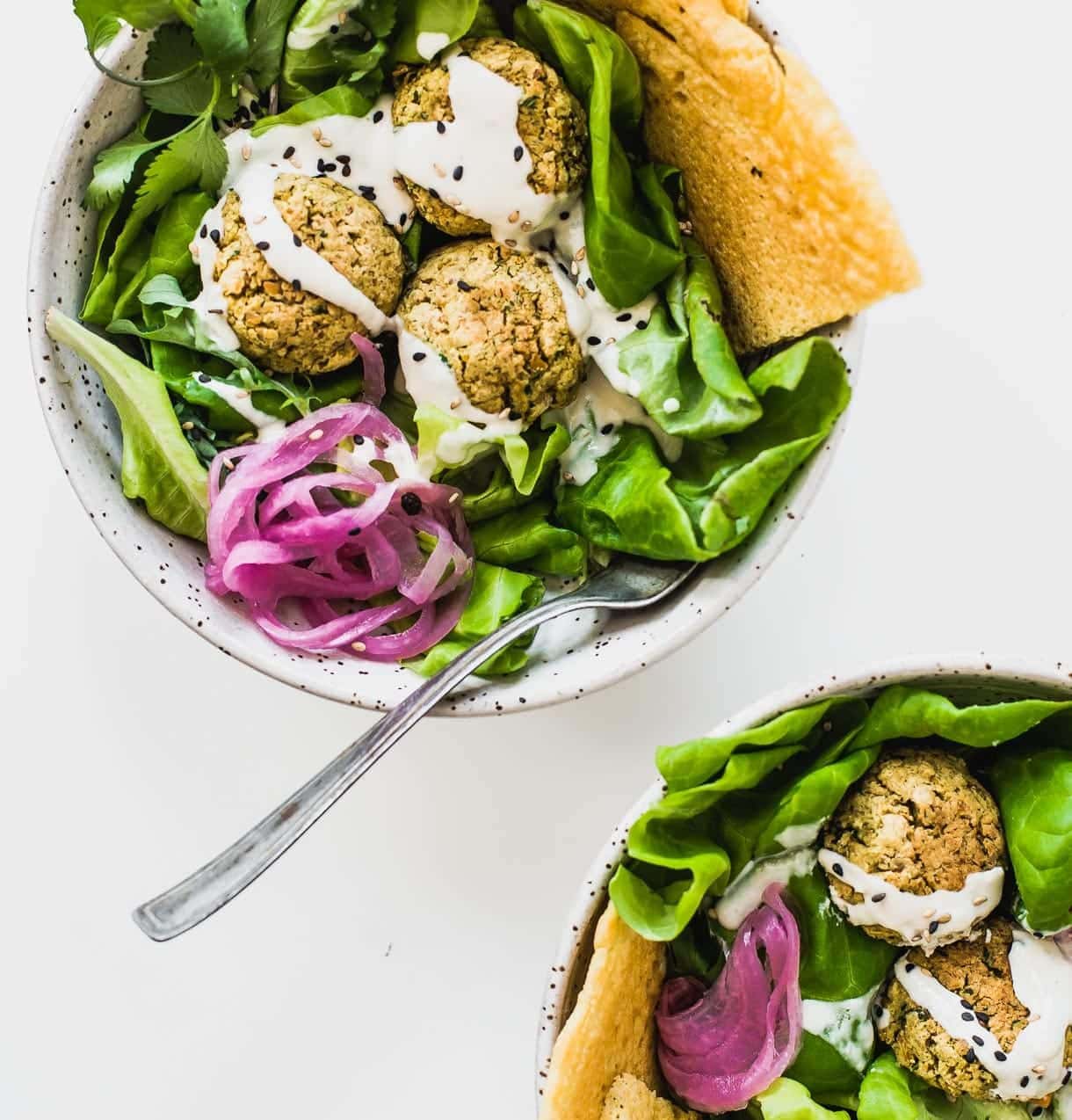 Baked Falafel Salad Recipe -- heathy and vegan! two bowls of baked falafel salad, overhead view.