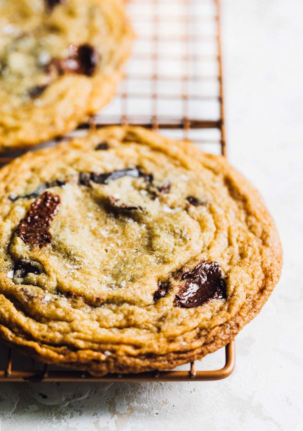 chocolate chip cookie, closeup, on a copper baking rack