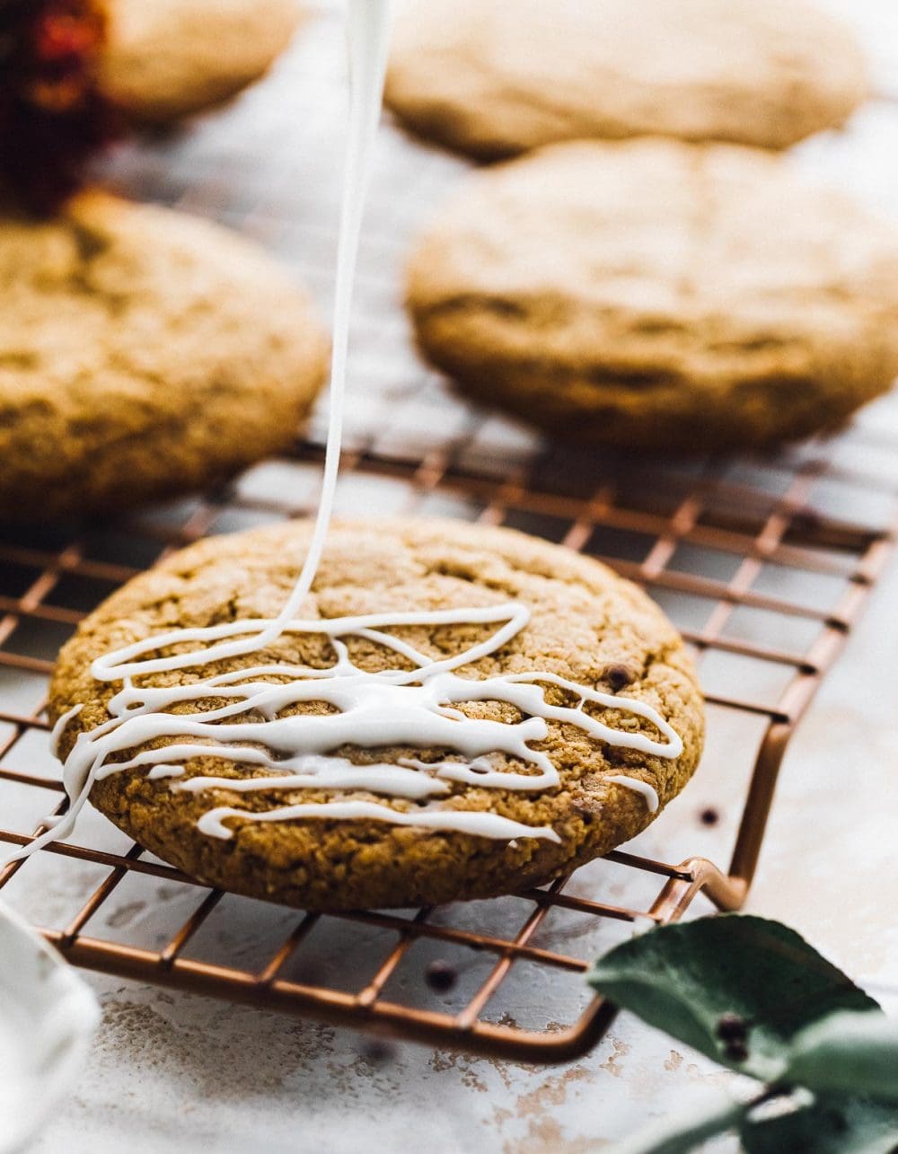 drizzling icing on pumpkin cookies