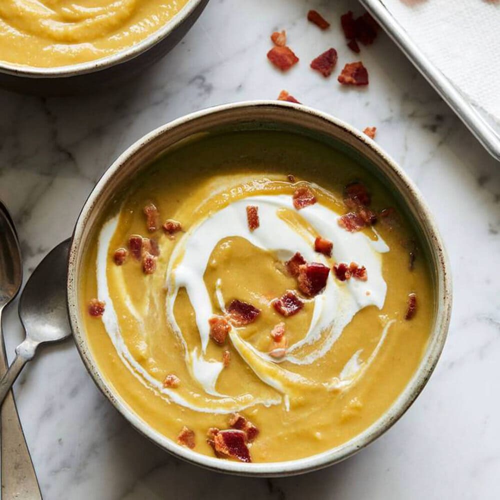 split pea soup with sour cream and bacon on top