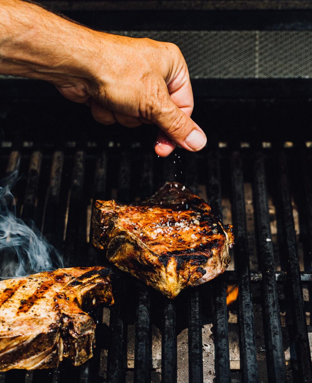 seasoning pork chops on the grill