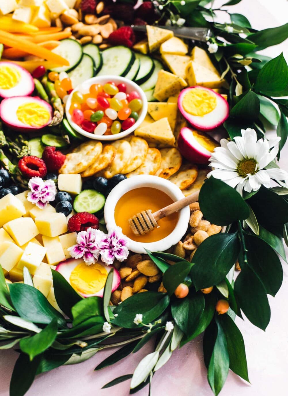 spring cheeseboard with fresh greens and flowers