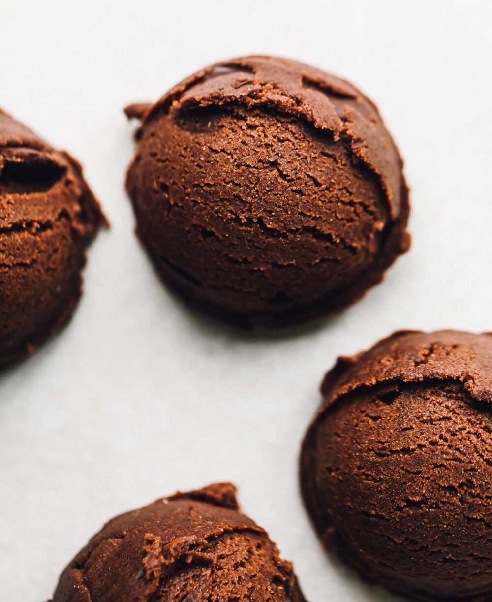 chocolate cookie dough balls on parchment paper