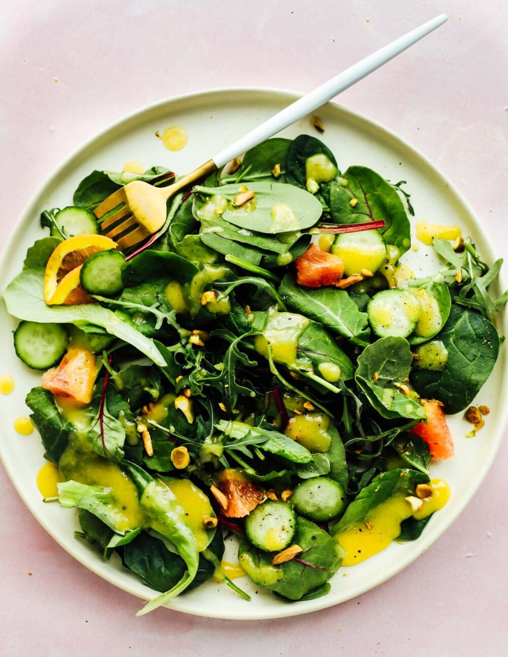 green salad with white balsamic vinaigette, on white plate