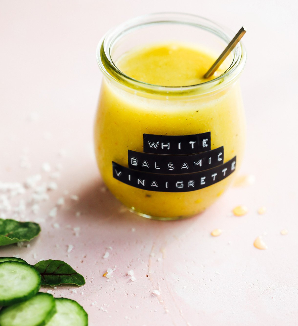 white balsamic vinaigrette in a glass jar on pink surface