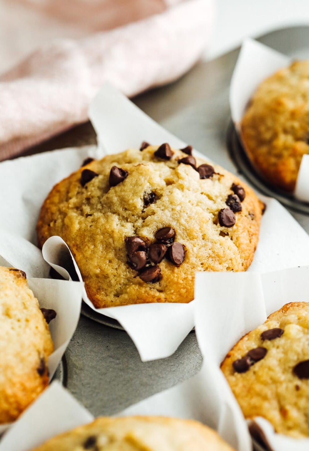 banana chocolate chip muffins in a muffin tin