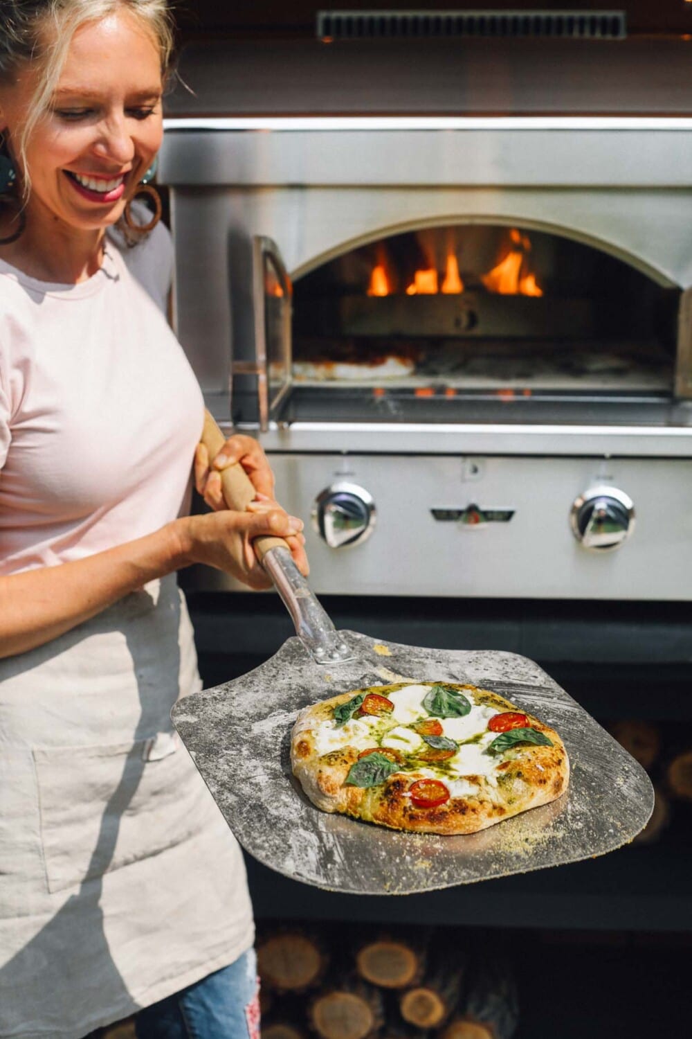 making pizza in an outdoor pizza oven using a pizza peel
