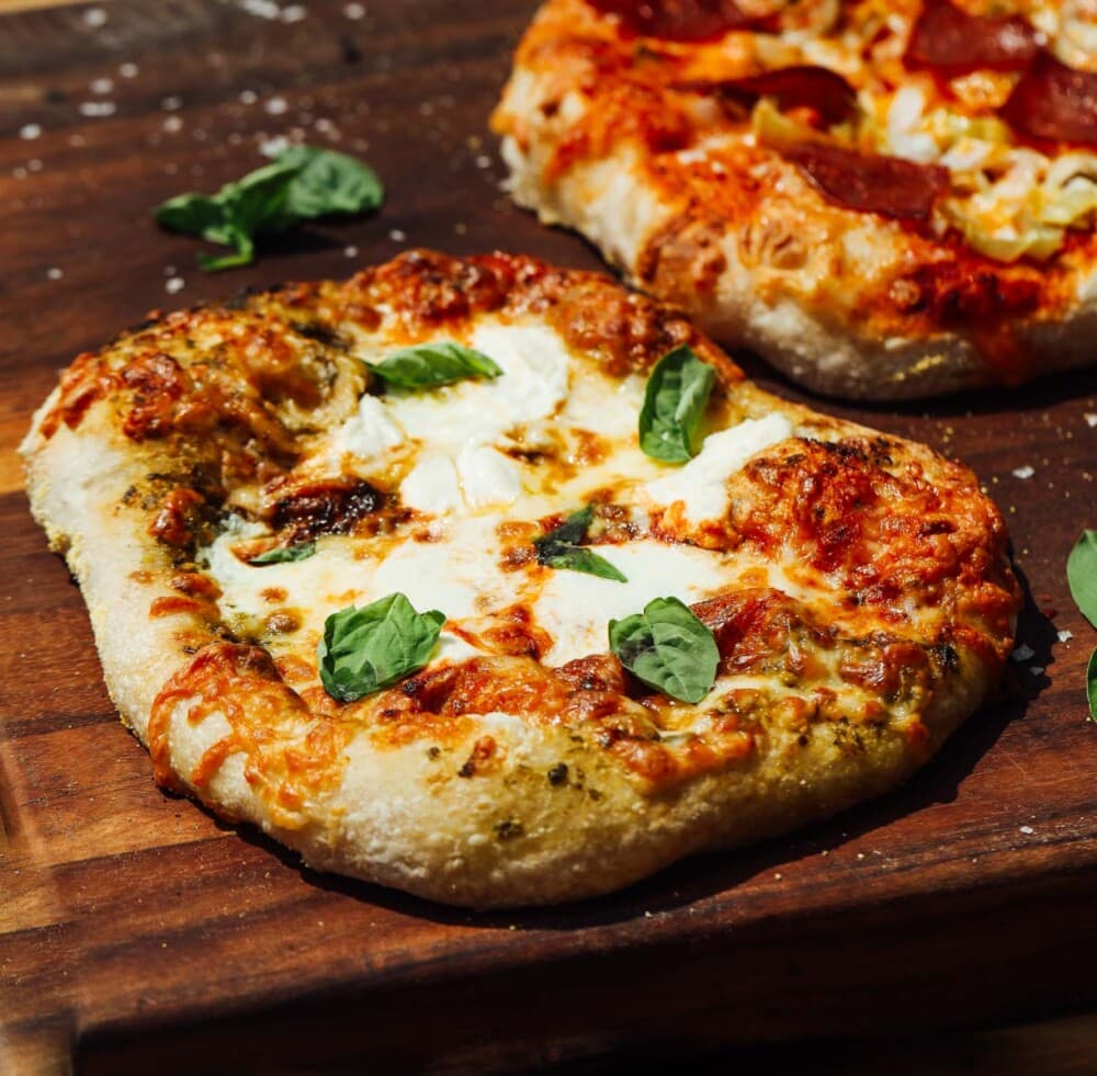 sourdough pizza made on a wooden cutting board