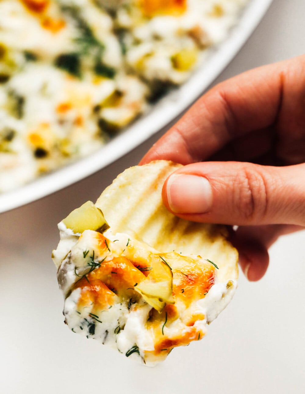 baked pickle dip on a potato chip