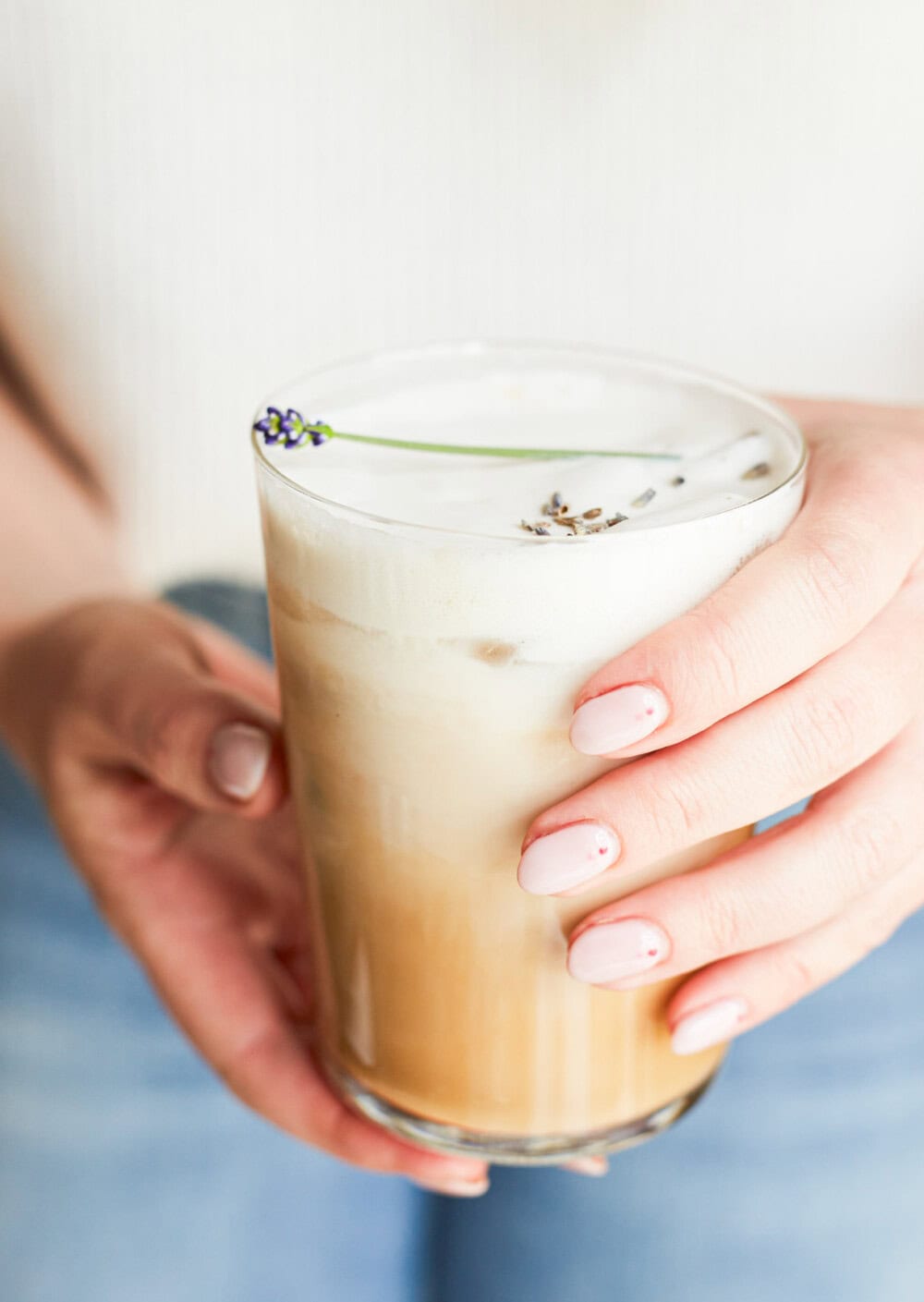 woman holding lavender latte