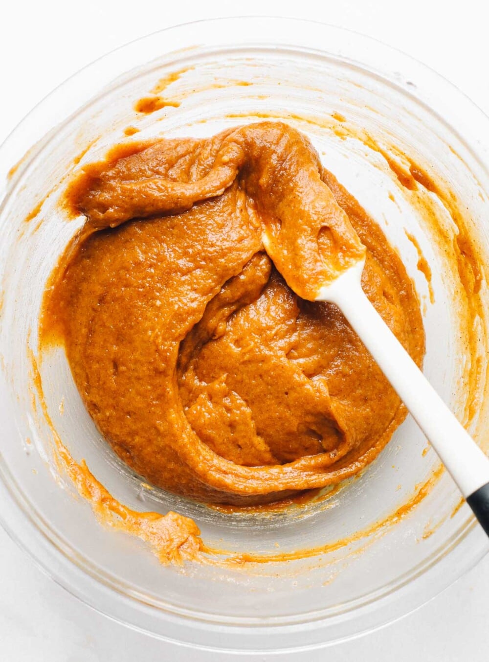 pumpkin bar batter in a clear bowl with spatula