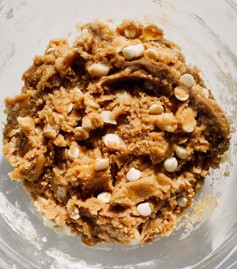 white chocolate macadamia nut cookie dough in a glass bowl