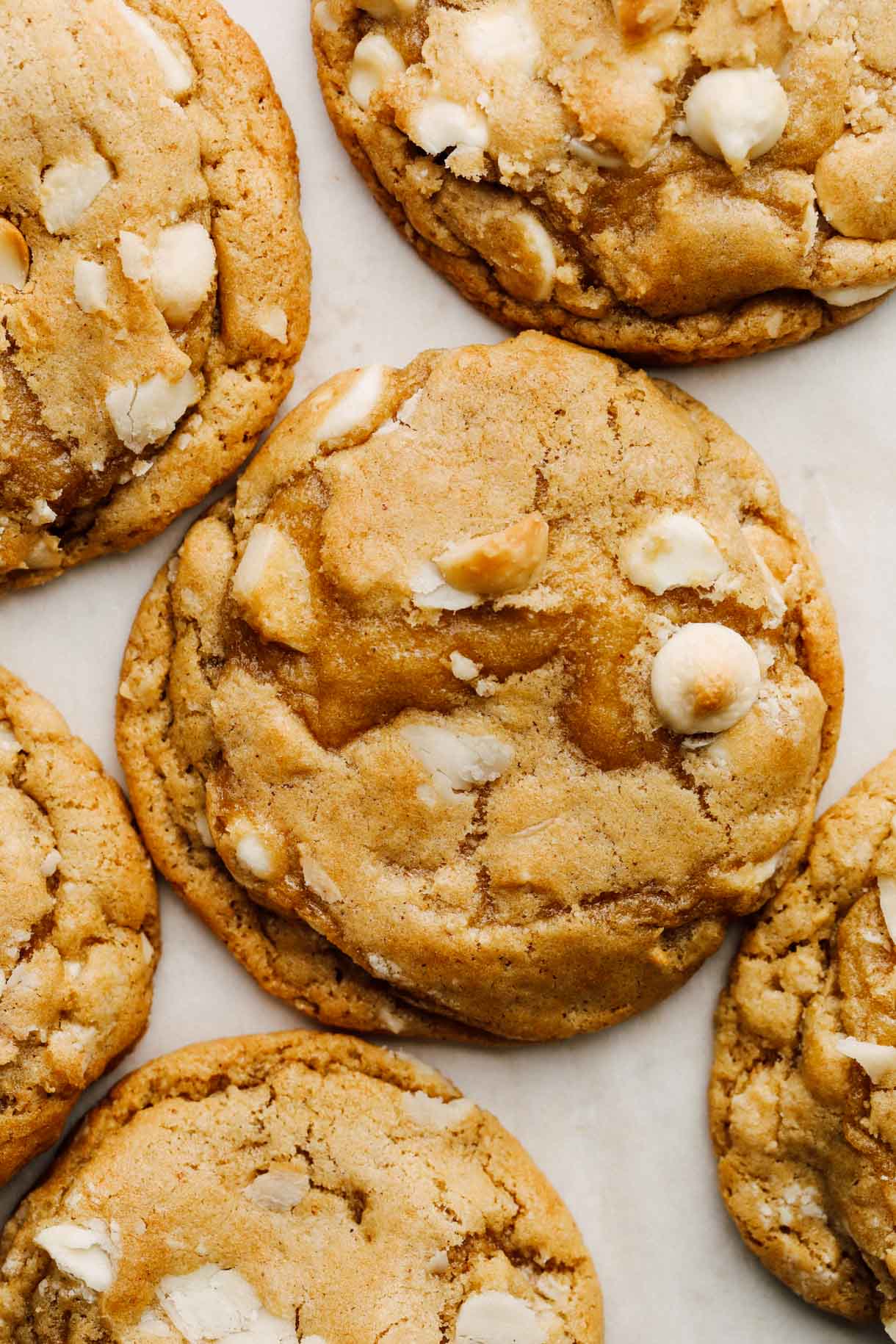 sourdough white chocolate macadamia nut cookies on parchment paper