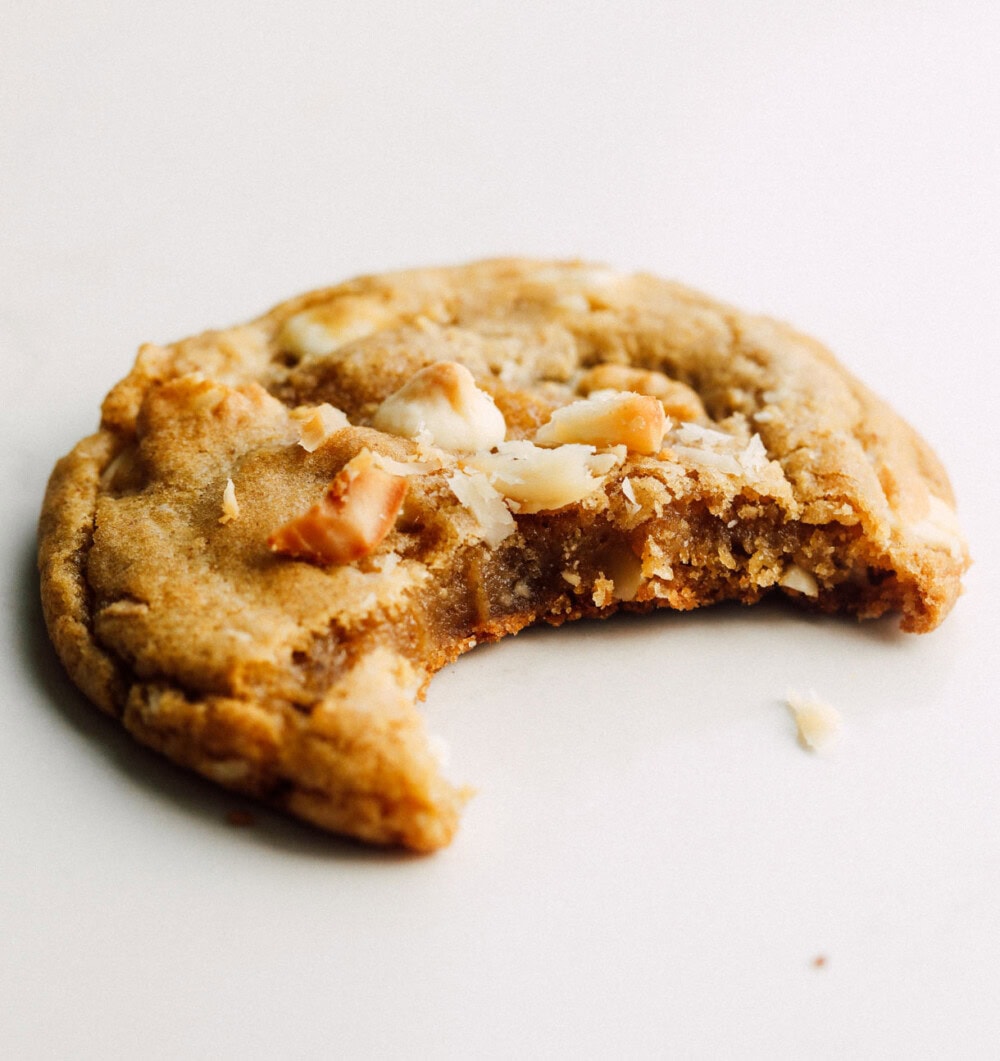 white chocolate macadamia nut cookie with bite out of it