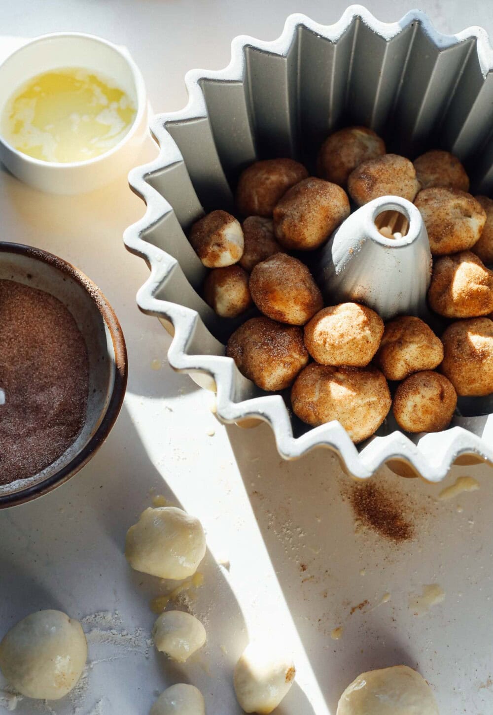 dough balls put into bundt pan for monkey bread