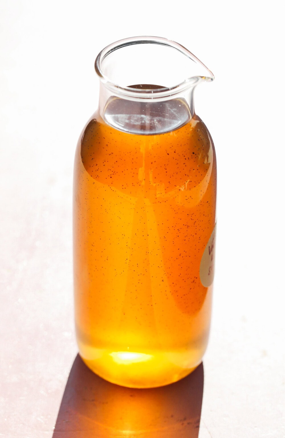 vanilla bean syrup in a clear glass bottle