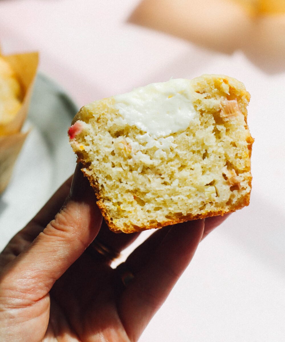 holding a cream cheese rhubarb muffins