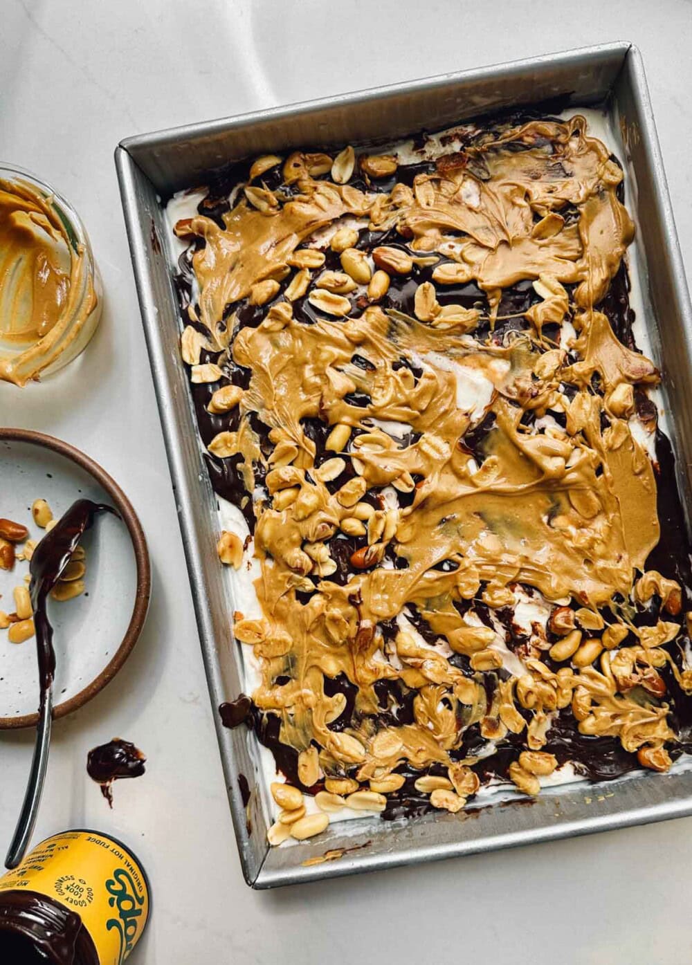 peanuts, hot fudge, and peanut butter swirled on ice cream