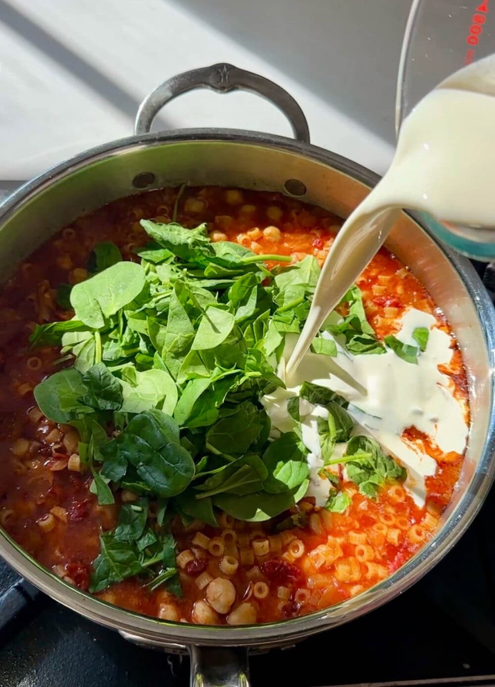 Healthy chickpea soup with fresh greens and cream